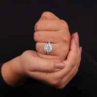 Hand holding a diamond ring against a black background, Dainty Moissanite Halo Bridal Jewelry, Elegant Moissanite Engagement Set, 14K Gold Moissanite Bridal Ring