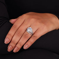 Close-up of a hand wearing a diamond ring on a black background, Halo Art Deco Round Moissanite Bridal Ring Set, Art Deco Moissanite Engagement Ring, Vintage Moissanite Wedding Set