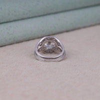 Silver ring with a textured band on a light surface, Classic Halo Bridal Jewelry, Wedding Ring Set For Brides, Durable Moissanite Bridal Set.