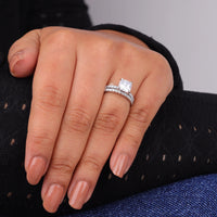 Close-up of a hand wearing a diamond ring with a blurred background, Cushion & Round Moissanite Wedding Bridal Ring Set 14K Gold, Cushion Cut Moissanite Engagement Ring