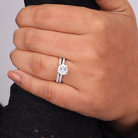 Hand wearing a diamond ring on a neutral background, Round Moissanite Wedding Band, Moissanite Bridal Set For Women, Cushion Moissanite Halo Engagement Ring