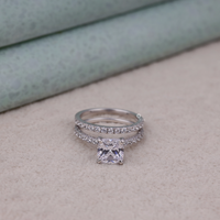 Silver ring with a square-cut gemstone on a neutral background, Dainty Round Moissanite Wedding Band, Affordable Moissanite Bridal Ring Set, 14K Gold Moissanite Wedding Jewelry