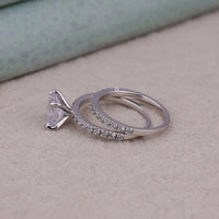 Two silver rings with diamond accents on a light surface, Sparkling Cushion Moissanite Anniversary Ring, Conflict Free Moissanite Bridal Set, Modern Cushion And Round Engagement Ring