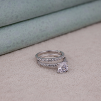 Silver ring with a pink gemstone on a neutral background, Wedding Band And Engagement Ring Set, Elegant Moissanite Bridal Jewelry For Women.