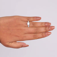 Hand wearing a diamond ring on a light gray background, Timeless Cushion Cut Bridal Jewelry, Classic Round Moissanite Bridal Ring Set, Moissanite Engagement Ring With Matching Band