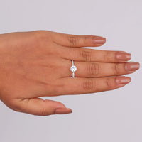 Hand wearing a diamond ring on a plain background, 14K Gold Hidden Halo Ring, Affordable Moissanite Engagement Ring, Round Halo Engagement Ring