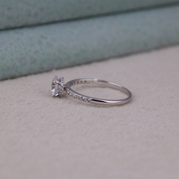 Silver ring with a diamond on a light gray surface, Unique Moissanite Engagement Jewelry, Hidden Halo Bridal Ring, Timeless Round Cut Engagement Ring