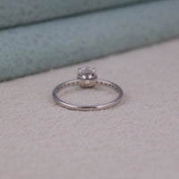 Silver ring with a diamond on a textured surface, Brilliant Moissanite Hidden Halo Ring, Moissanite Solitaire Ring with Halo, Delicate Hidden Halo Engagement Ring