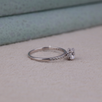 Silver ring with a diamond on a textured surface, Fire and Sparkle Moissanite Ring, Modern Hidden Halo Moissanite Bridal Ring, Elegant Round Moissanite Engagement Ring