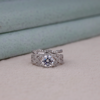Silver ring with a large diamond on a light gray surface