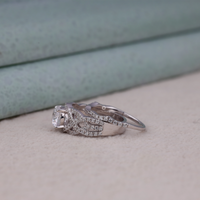 Silver ring with diamond accents on a neutral background