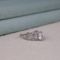 Silver ring with a large diamond on a soft surface