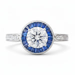 Diamond ring with blue gemstones on a white background