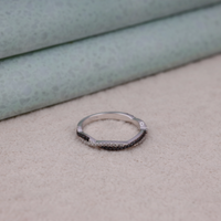 Silver ring with black stones on a textured surface, Eco Friendly Moissanite Anniversary Band, Conflict Free Black and White Moissanite Ring, Elegant Twisted Moissanite Eternity Band