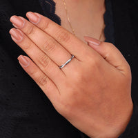 Hand wearing a silver ring with a blurred background, Round Black & White Moissanite Twisted Shank Half Eternity Band, Black and White Moissanite Wedding Band