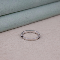 Silver ring on a textured surface, Contemporary Half Eternity Ring For Brides, Classic Black and White Moissanite Eternity Jewelry