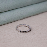Silver ring with small stones on a textured surface, Sparkling Twisted Anniversary Band, Unique Everyday Wear Moissanite Ring.