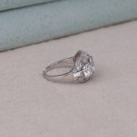 Silver ring with a diamond on a light gray surface, cubic zirconia three stone wedding ring for women, art deco inspired promise ring with CZ stones