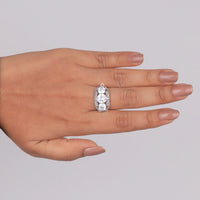 Diamond ring on a hand against a gray background, antique art deco ring with round cut CZ, vintage style cubic zirconia wedding jewelry