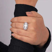 Hand wearing a diamond ring on a plain background, affordable CZ engagement ring for women, round cut CZ vintage inspired jewelry, art deco style promise ring with cubic zirconia 