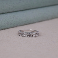 Stack of silver rings with gemstones on a neutral background, Lab Created Moissanite Half Band, Baguette and Round Moissanite Ban