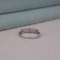 Silver ring on a textured surface with a neutral background, Moissanite Promise Band, Bridal Moissanite Eternity Ring, Modern Dot Dash Eternity Band