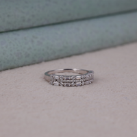 Stack of silver rings with gemstones on a neutral background, Baguette & Round Cut Moissanite Dot Dash Half Eternity Band Ring, Moissanite Half Eternity Band, Baguette Moissanite Wedding Band