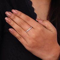 Hand wearing a silver ring with a blurred background, Moissanite Stackable Band Ring, Vintage Seven Stone Ring, Elegant Moissanite Wedding Ring