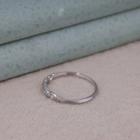 Silver hoop earring with embedded stones on a textured surface, Art Deco Inspired Moissanite Ring, Heirloom Style Ring, Moissanite Ring For Her, Classic Edwardian Wedding Band