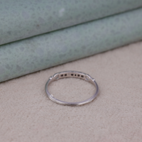 Silver ring on a textured surface with a light green background, Vintage Moissanite Jewelry, Round Brilliant Cut Band Ring, Old World Style Moissanite Ring