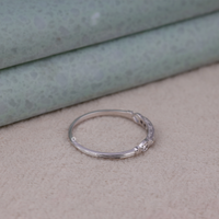 Silver bracelet with small stones on a textured surface, Sparkling Seven Stone Band, Moissanite Ring For Bride, Edwardian Band Ring For Women