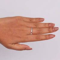 Hand wearing a diamond ring on a light gray background, Edwardian Engagement Band, Delicate Moissanite Ring, 7 Stone Band Ring, Moissanite Bridal Jewelry