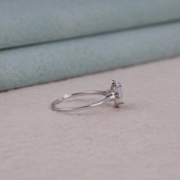 Silver ring with a small stone on a beige surface, Romantic Emerald Cut Moonstone Engagement Ring, Modern Minimalist Moonstone Five Stone Band, Moonstone Ring With White CZ Side Stones