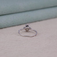 Silver ring with a diamond on a light gray surface, Sterling Silver Emerald Cut Rainbow Moonstone Ring | Delicate Stacking Jewelry