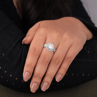 Close-up of a hand wearing a silver ring with a diamond on a black background, Halo Moissanite Bridal Jewelry, Cushion Moissanite Ring With Enhancer, 14K Gold Moissanite Bridal Ring Set,