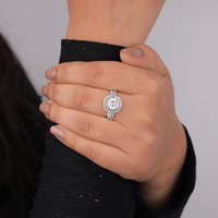 Close-up of a hand wearing a diamond ring on a neutral background, Sparkling Cushion Halo Wedding Ring, Timeless Moissanite Bridal Guard Set, Sustainable Cushion Moissanite Engagement Ring,