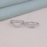 Two silver rings on a light pink surface with a soft blue background, Sustainable Cushion Moissanite Engagement Ring, Conflict Free Moissanite Wedding Jewelry, Elegant Halo Guard Bridal Set For Women,