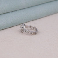 Silver ring with a diamond on a light gray surface, Affordable Moissanite Wedding Ring Set, Cushion Cut Moissanite Promise Ring, Dainty Moissanite Halo Enhancer Ring, Modern Cushion Halo Engagement Ring, Durable Bridal Ring Guard With Cushion Stone,