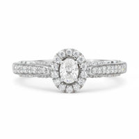 Diamond ring with a halo and pavé setting on a white background