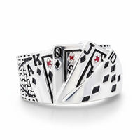 Silver ring with playing card suits design on a white background