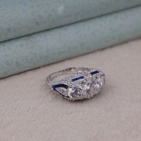 Diamond ring with blue accents on a textured surface