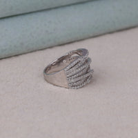 Silver ring with multiple bands on a light surface, Minimalist Criss Cross Moissanite Ring, Chic Round Cut Moissanite Bridal Jewelry, Classic Moissanite Crisscross Wedding Band