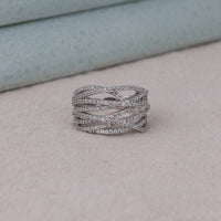 Silver ring with criss-cross design on a light gray surface, Versatile Moissanite Fashion Band, Glamorous Round Moissanite Statement Ring, Elegant Moissanite Promise Band