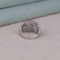 Silver ring with multiple bands on a textured surface, Chic Round Cut Moissanite Bridal Jewelry, Classic Moissanite Crisscross Wedding Band, Unique Modern Moissanite Cocktail Ring For Women.