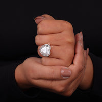 Heart-shaped diamond ring on a hand against a black background, Halo Heart & Round Moissanite Engagement Ring | Dainty Bridal Jewelry