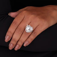 Heart-shaped diamond ring on a hand against a black background, Moissanite Halo Engagement Ring | Heart & Round Cut Bridal Ring