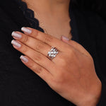 Hand wearing a silver ring with a black background, Bubble Bezel Set Round Moissanite Multi Layer Ring – Modern Wedding Band for Women