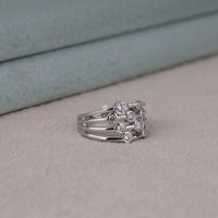 Three silver rings with gemstones on a light gray surface, Stackable Round Moissanite Bubble Bezel Ring – Multi Layer Modern Wedding Band