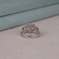 Silver ring with intricate design on a light gray surface, Unique Bubble Bezel Moissanite Ring – Multi Layer Round Stone Wedding Band