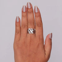 Hand wearing a silver ring with a gray background, Round Moissanite Stackable Ring – Bubble Bezel Multi Layer Wedding Band